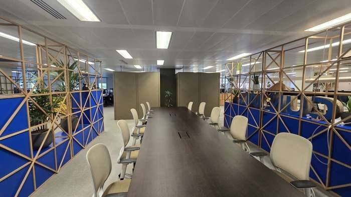 Boardroom table between screened workstations