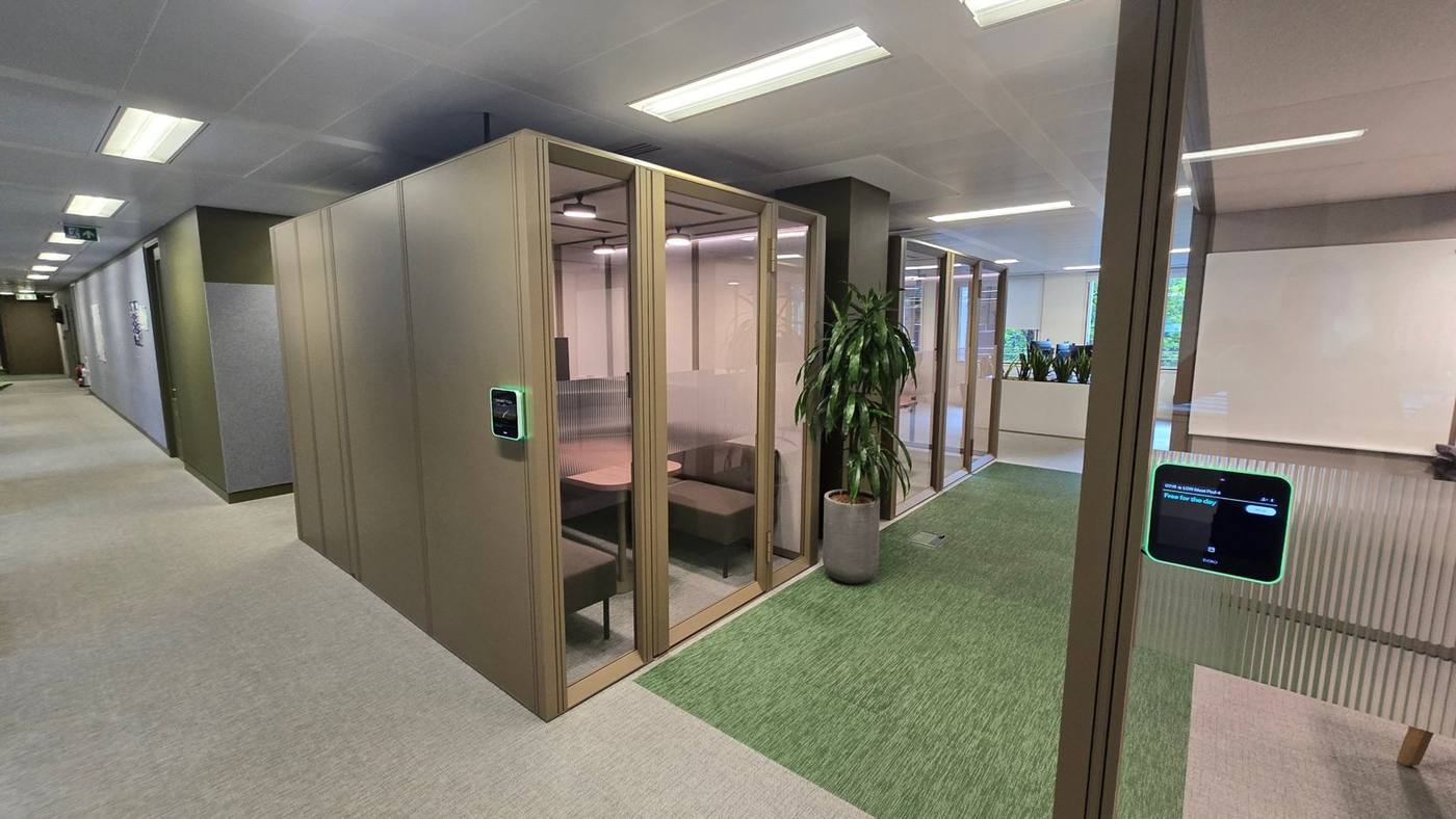 Glazed meeting pods with booking screens
