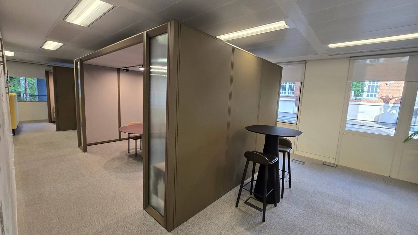 Open meeting pod beside a poseur table